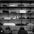 grayscale photography of assorted apparels on shelf rack